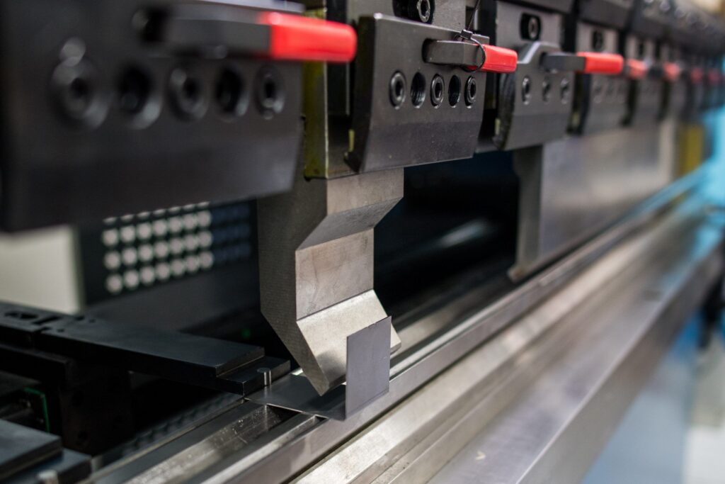 Close-up of a precision press brake punch positioned over the die, ready for accurate sheet metal bending. The hardened tooling ensures clean bends, high repeatability, and reliable performance in industrial production.