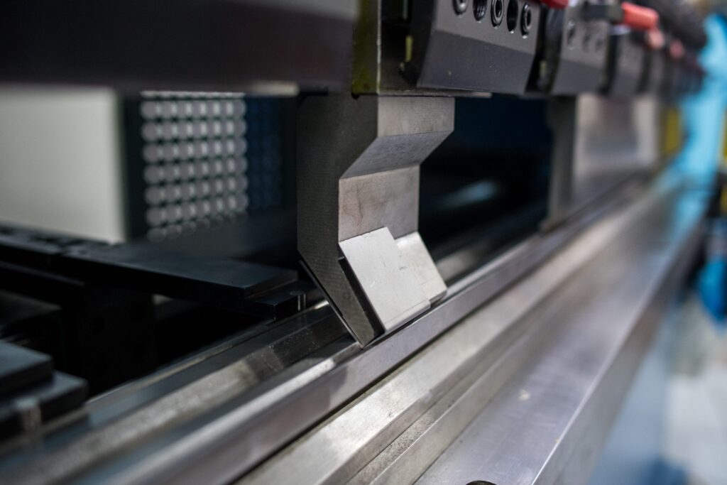 Close-up of a precision press brake punch positioned over the die, ready for accurate sheet metal bending. The hardened tooling ensures clean bends, high repeatability, and reliable performance in industrial production.