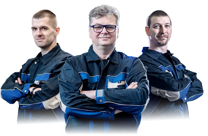 Three experienced technicians in work uniforms standing confidently with arms crossed, representing a professional industrial team.