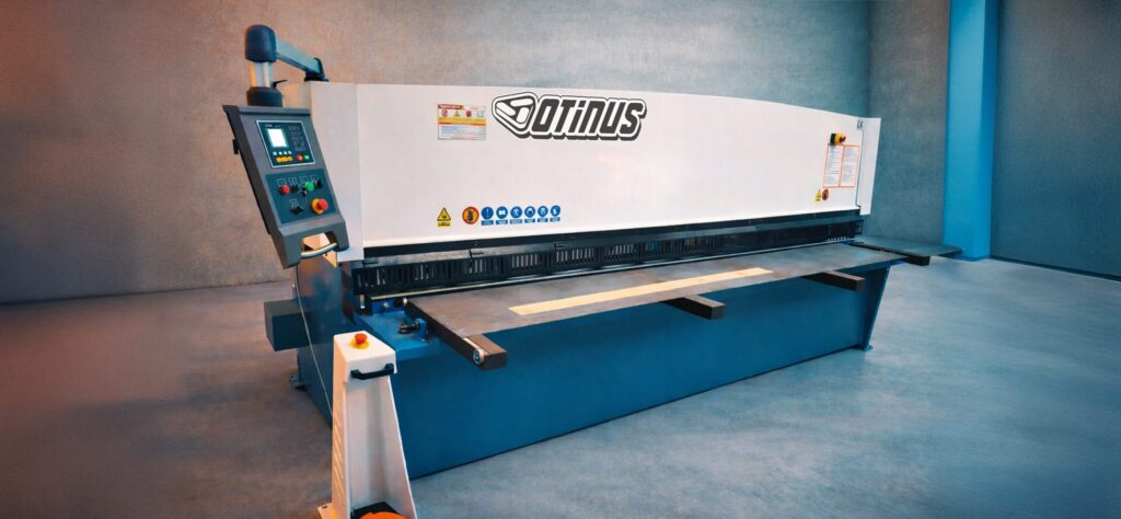Otinus Base guillotine shears with a CNC control panel, designed for precise and safe sheet metal cutting, presented in a modern and well-organized industrial environment.