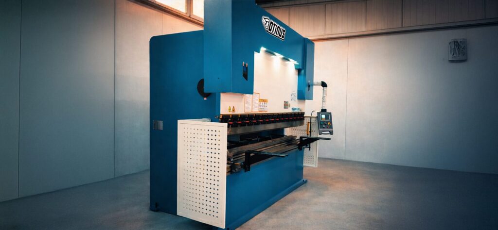 Side view of an industrial Otinus press brake with an ESTUN control system, equipped with precision bending tools and an operator panel, located in a production hall.