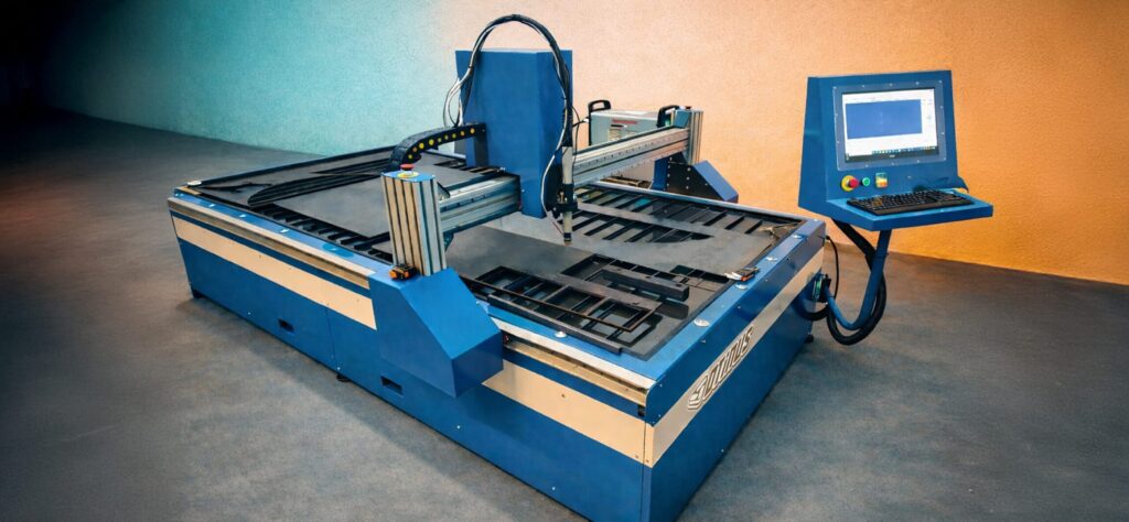 Modern CNC plasma cutting machine with a water table and control panel, designed for precise and efficient sheet metal cutting in industrial conditions.