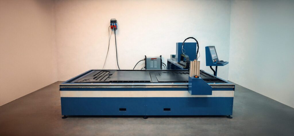 Modern CNC plasma cutting machine with a water table and control panel, designed for precise and efficient sheet metal cutting in industrial conditions.
